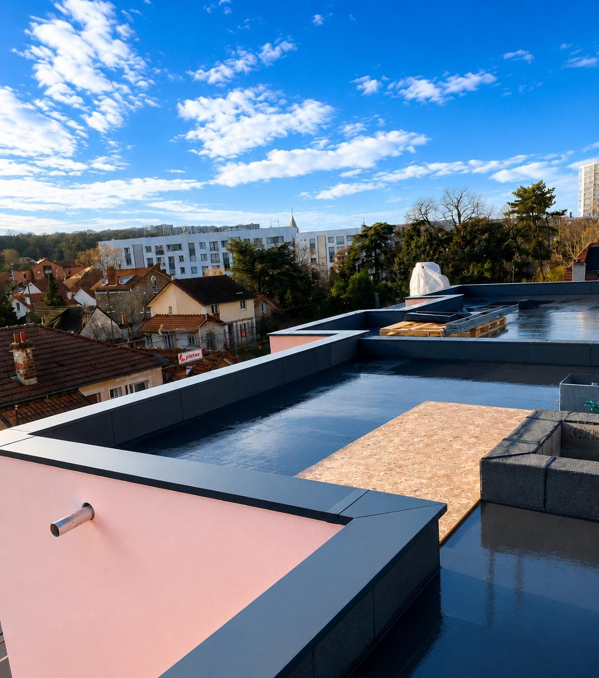 Couvertines anthracite en tête de relevés d'étanchéité sur une toiture-terrasse en chantier.